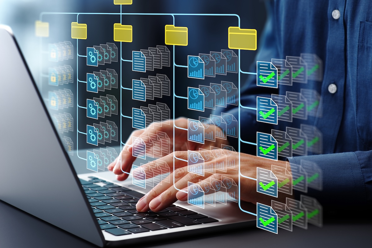 Document management system DMS. Folder structure and classification system. File and folder icons. Businessman using laptop computer for controlling document versions.