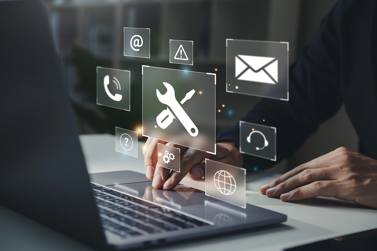 Businessman using laptop with helpdesk icon on screen, Hotline assistance service available by phone, chat, email, Technical support customer service concept.